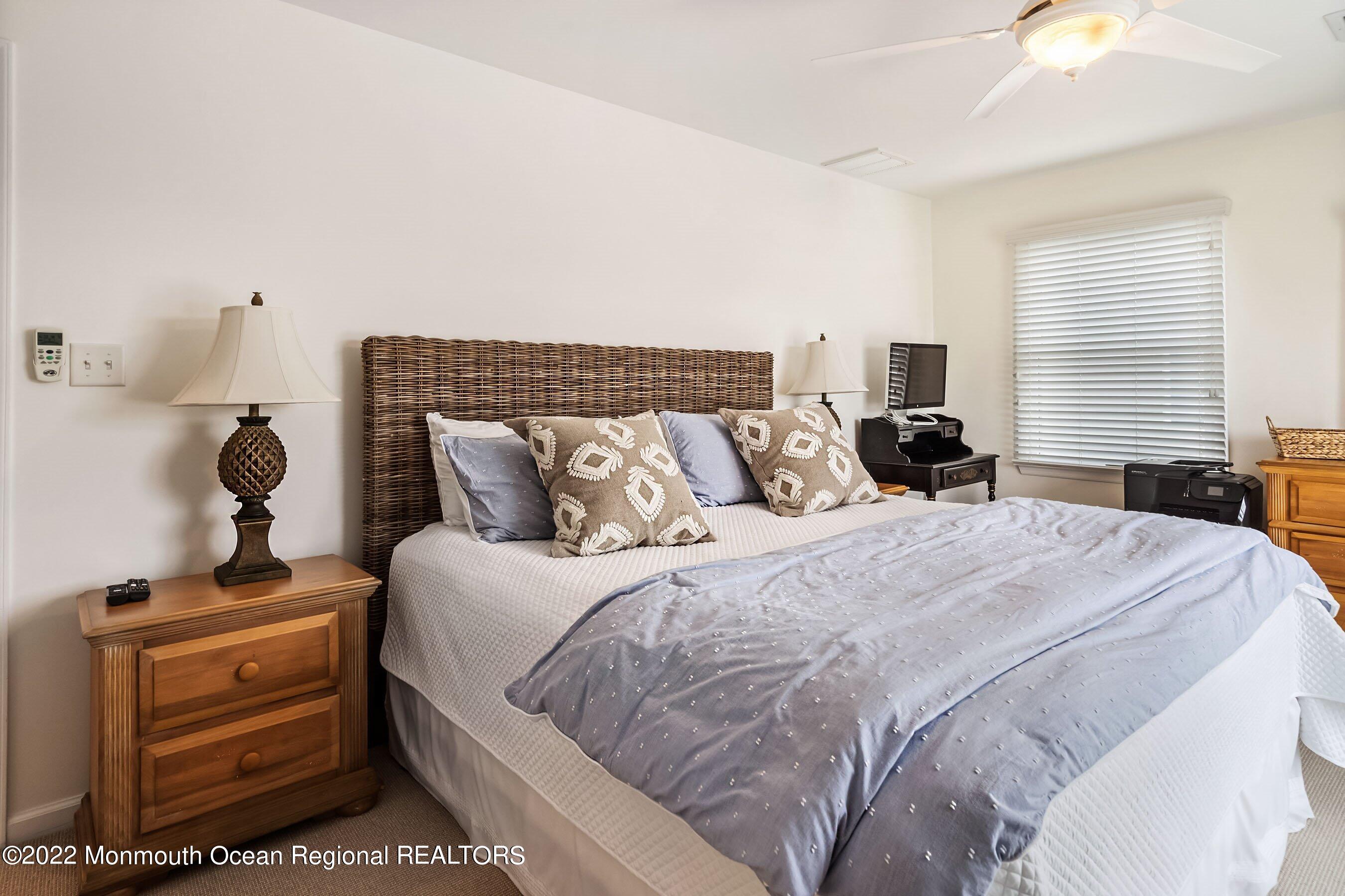 23 Magee Avenue, Unit SUMMER Lavallette, NJ 08735 - Photo 16 of 34 a bedroom with a bed and wooden floor