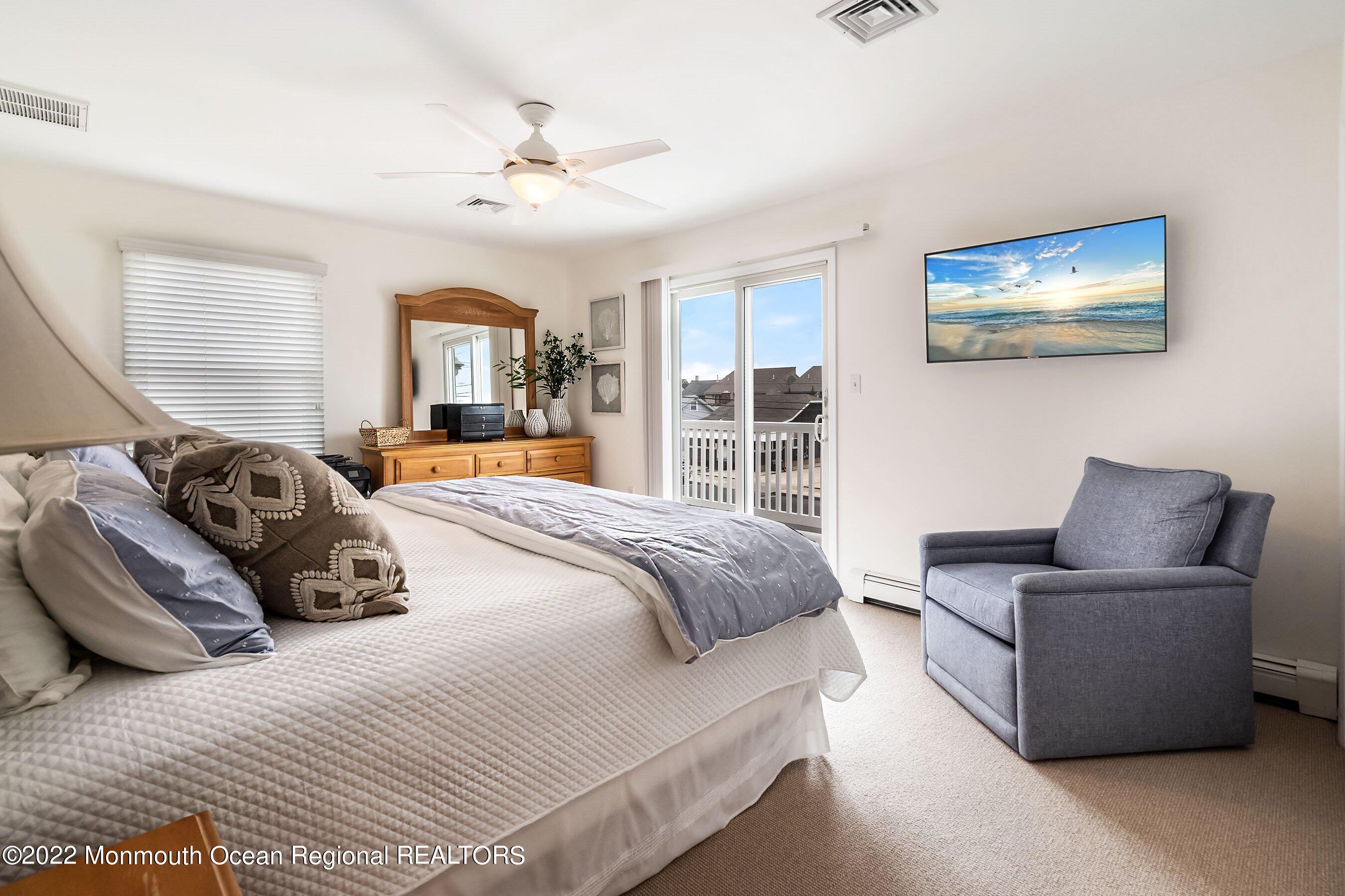 23 Magee Avenue, Unit SUMMER Lavallette, NJ 08735 - Photo 17 of 34 a bedroom with a large bed and a couch