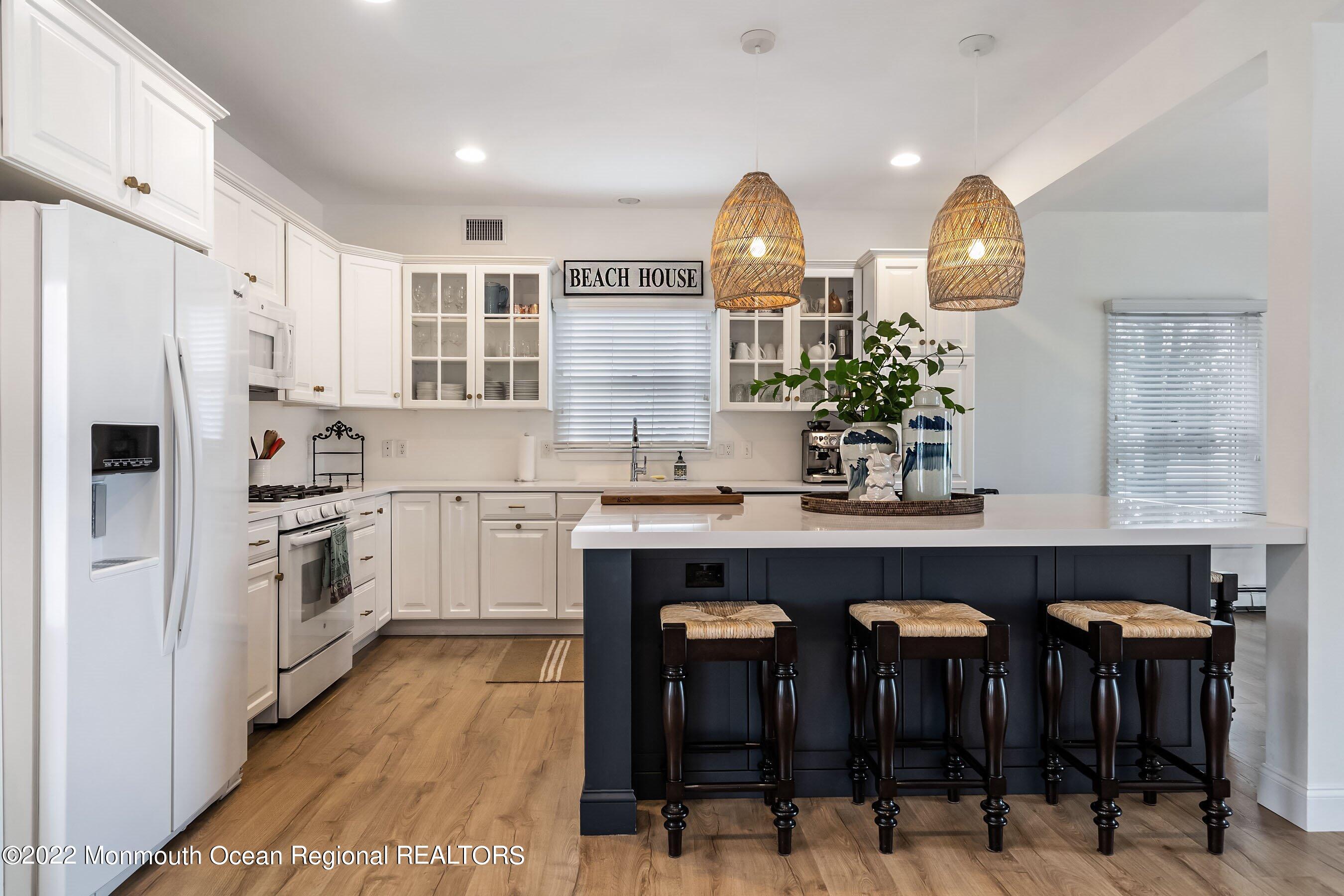 23 Magee Avenue, Unit SUMMER Lavallette, NJ 08735 - Photo 7 of 34 a kitchen with granite countertop a sink stainless steel appliances and cabinets