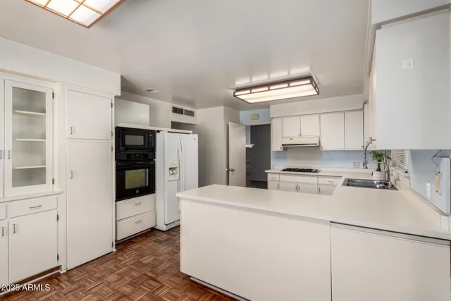a kitchen with stainless steel appliances a refrigerator and a stove top oven