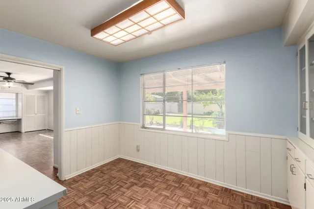 an empty room with windows and closet