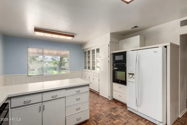 a kitchen with granite countertop a refrigerator and a stove