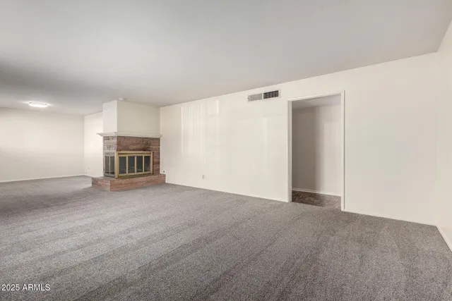 a view of empty room with a fireplace