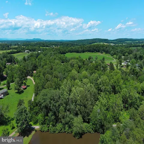 an aerial view of a houses with a yard