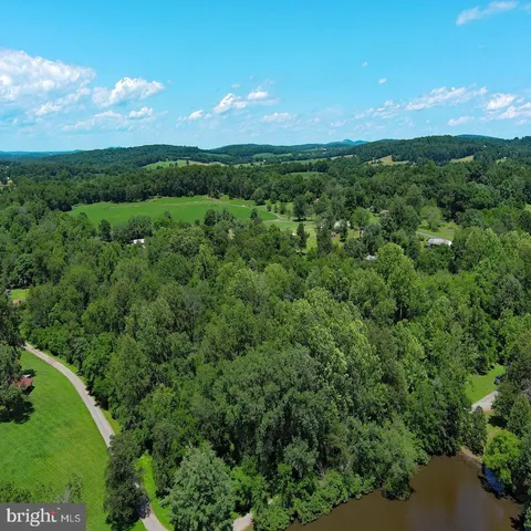 an aerial view of a houses with a yard