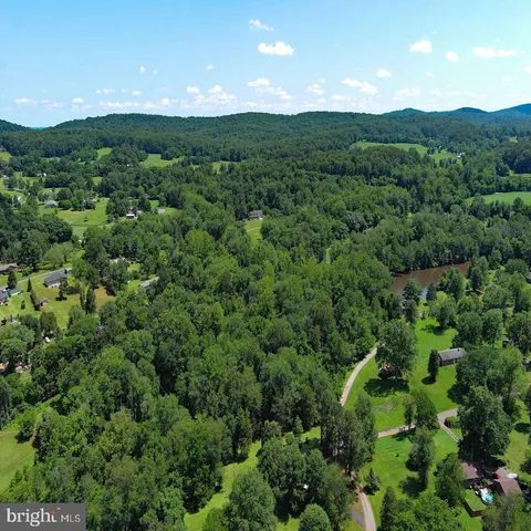 a view of a green field with lots of bushes