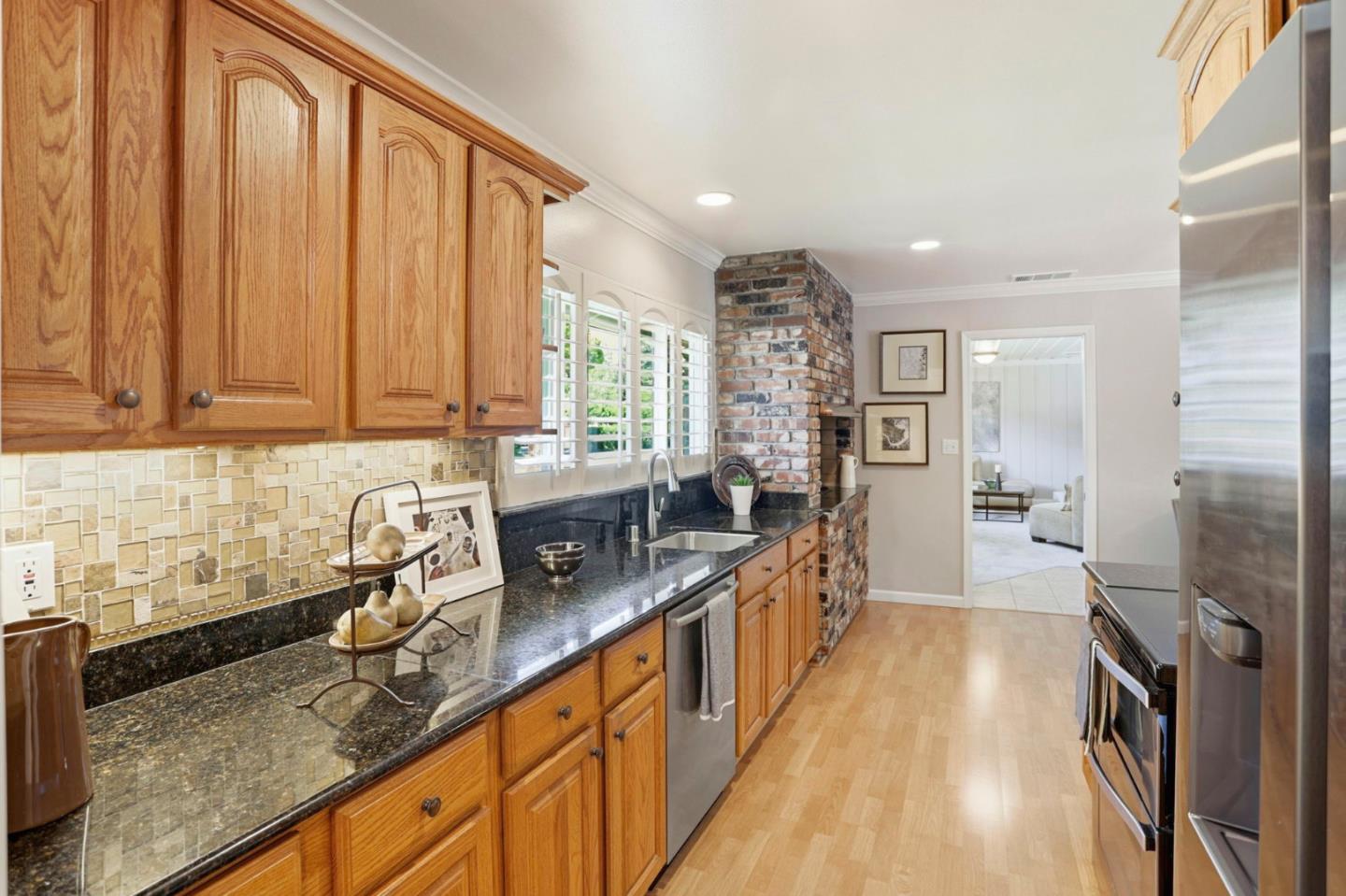 1701 Springer Road Mountain View, CA 94040 - Photo 11 of 48 a kitchen with granite countertop a sink a counter top space stainless steel appliances and cabinets