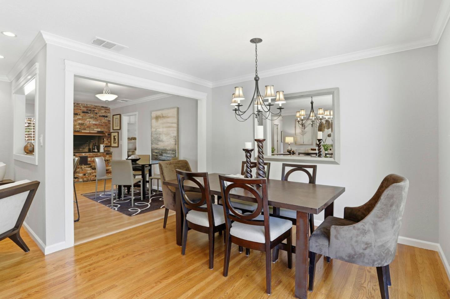 1701 Springer Road Mountain View, CA 94040 - Photo 17 of 48 a view of a dining room and livingroom with furniture wooden floor a chandelier