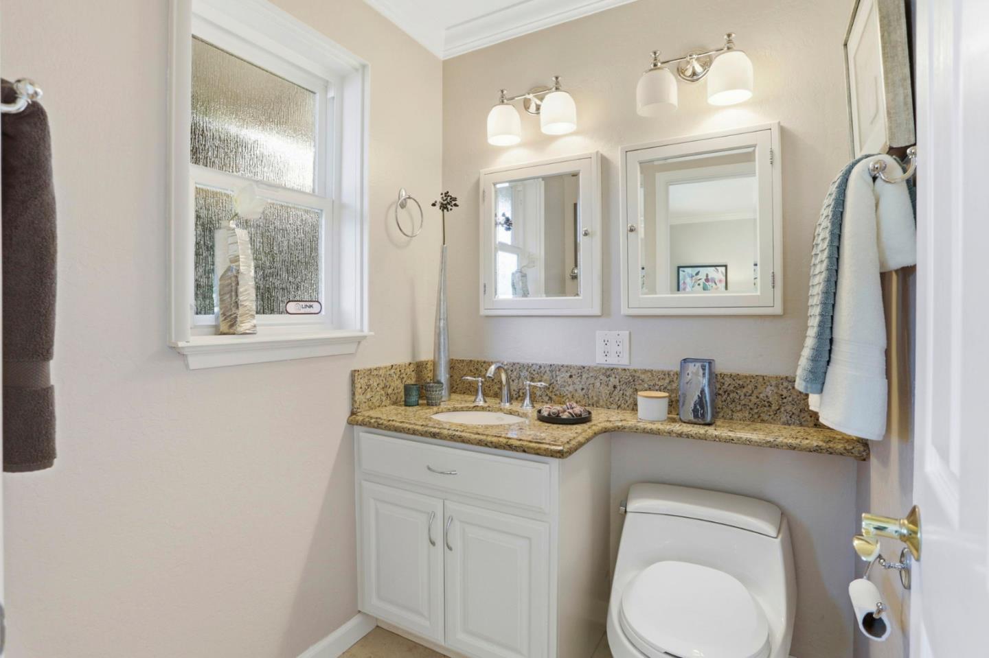 1701 Springer Road Mountain View, CA 94040 - Photo 26 of 48 a bathroom with a granite countertop sink toilet and mirror