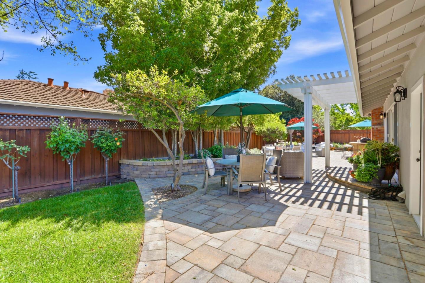 1701 Springer Road Mountain View, CA 94040 - Photo 29 of 48 a view of a patio with a table and chairs under an umbrella