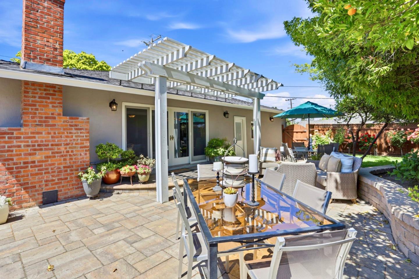 1701 Springer Road Mountain View, CA 94040 - Photo 30 of 48 a view of a patio with table and chairs potted plants and floor to ceiling window