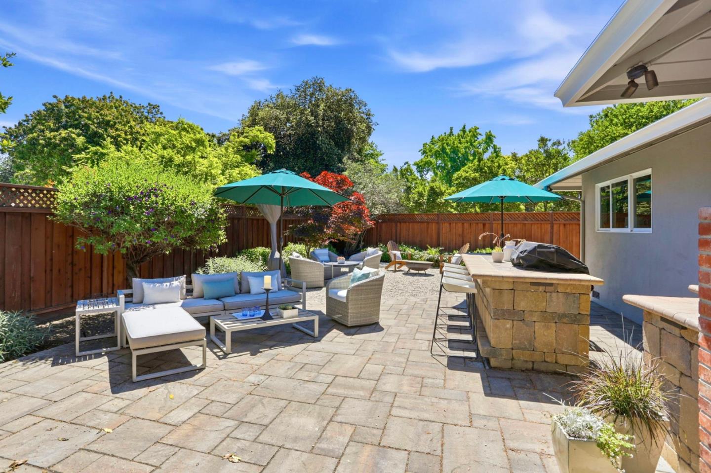 1701 Springer Road Mountain View, CA 94040 - Photo 31 of 48 a view of a patio with table and chairs potted plants with wooden fence