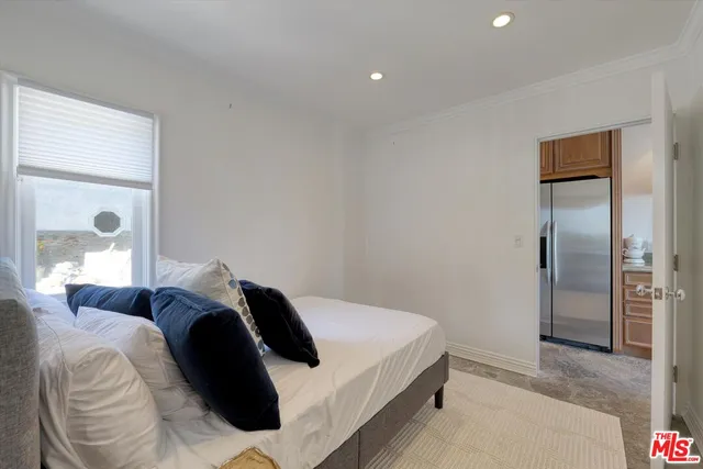 a bedroom with a bed and a mirror