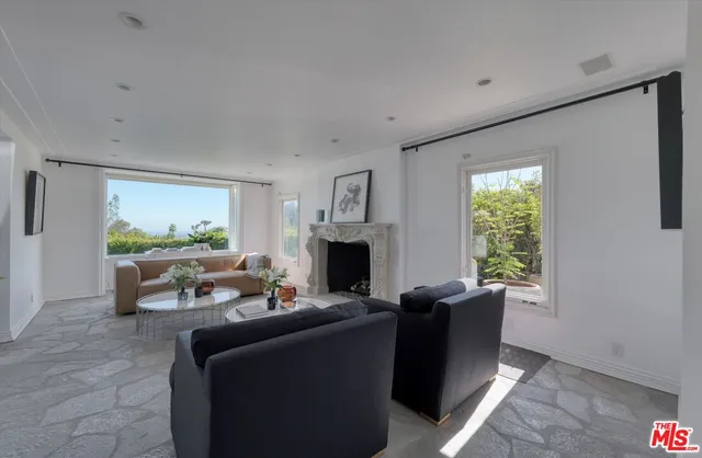 a living room with furniture a window and a fireplace