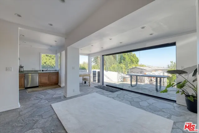 a living room with furniture a window and kitchen view