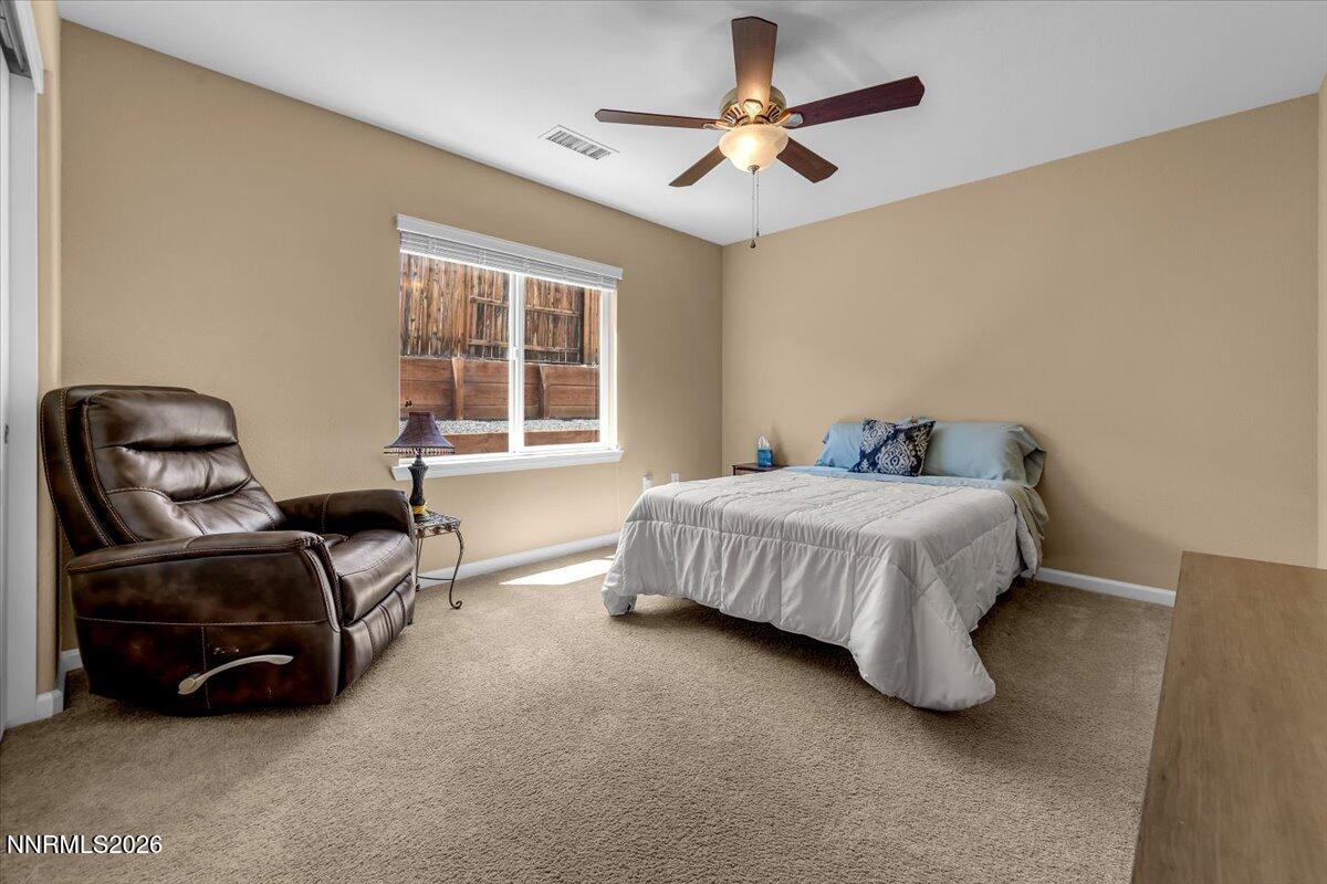104 Bethpage Road Dayton, NV 89403 - Photo 30 of 65 a bedroom with a bed a chair and a large window