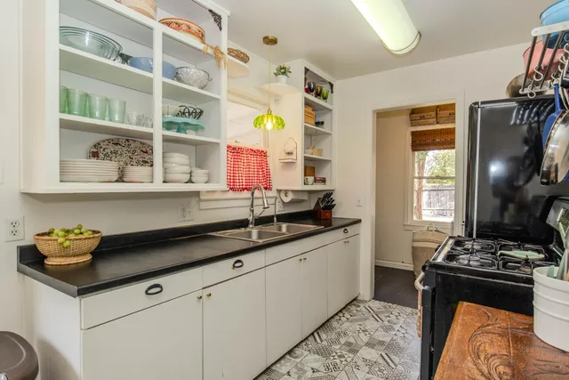 a kitchen with stainless steel appliances granite countertop a sink stove and cabinets