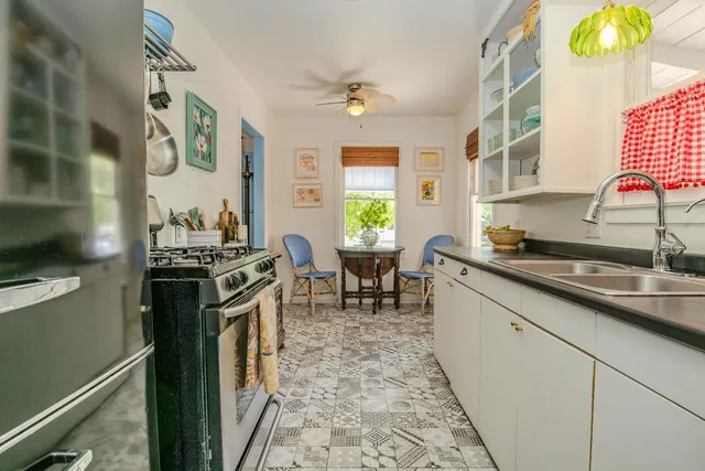 a kitchen with a sink stove and cabinets