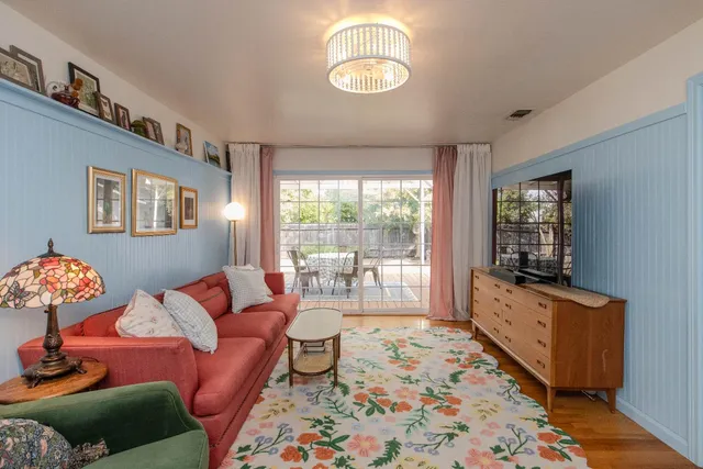 a living room with fireplace furniture and a floor to ceiling window