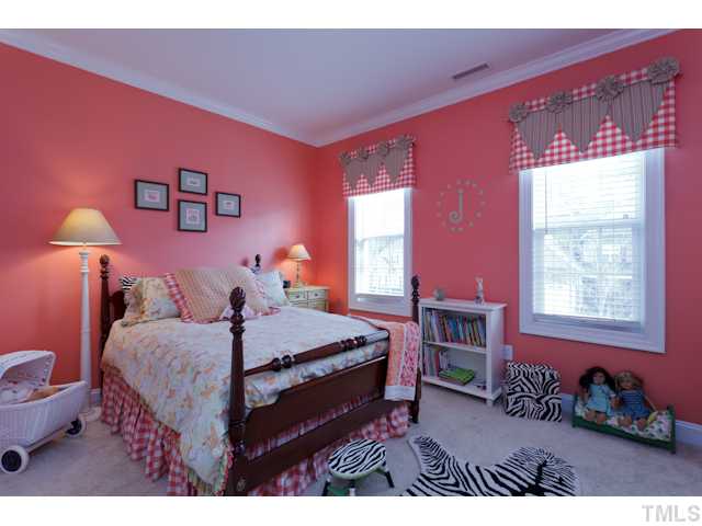 4216 Oakthorne Way Raleigh, NC 27613 - Photo 17 of 24 a bed room with a bed and a lamp