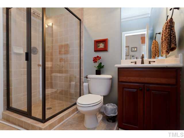 4216 Oakthorne Way Raleigh, NC 27613 - Photo 19 of 24 a bathroom with a sink a toilet a mirror and shower