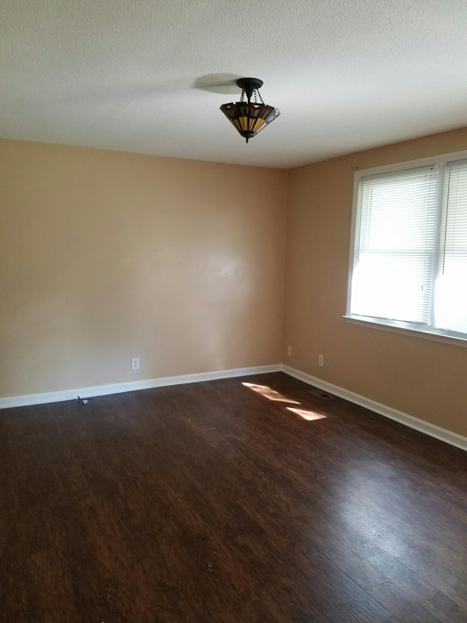 2430 Moody Road Clarksville, TN 37040 - Photo 3 of 15 a view of an empty room with wooden floor and a window