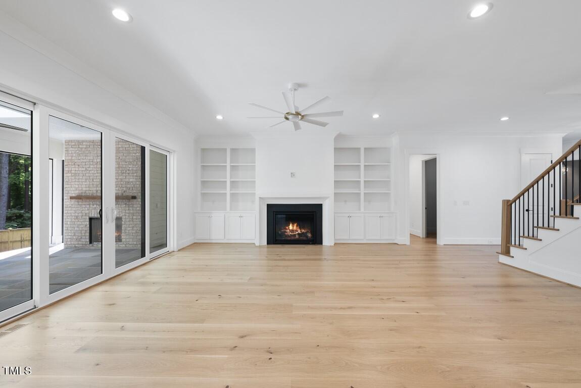 412 Vernon Terrace Raleigh, NC 27609 - Photo 12 of 67 a view of an empty room with a fireplace and a window