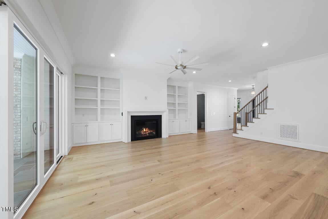 412 Vernon Terrace Raleigh, NC 27609 - Photo 13 of 67 a view of an empty room with a fireplace and a window