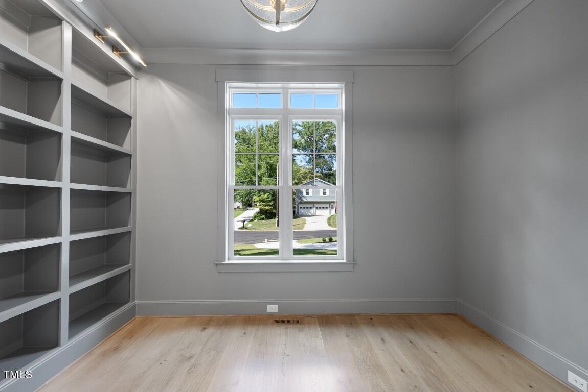 412 Vernon Terrace Raleigh, NC 27609 - Photo 20 of 67 a view of an empty room with wooden floor and a window
