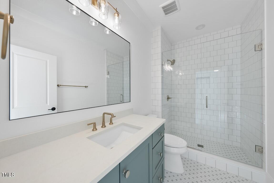 412 Vernon Terrace Raleigh, NC 27609 - Photo 31 of 67 a bathroom with a sink a toilet and shower