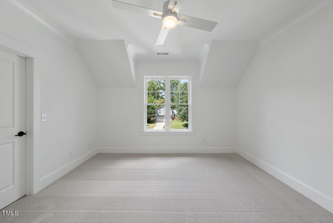 412 Vernon Terrace Raleigh, NC 27609 - Photo 34 of 67 an empty room with a window and a chandelier fan