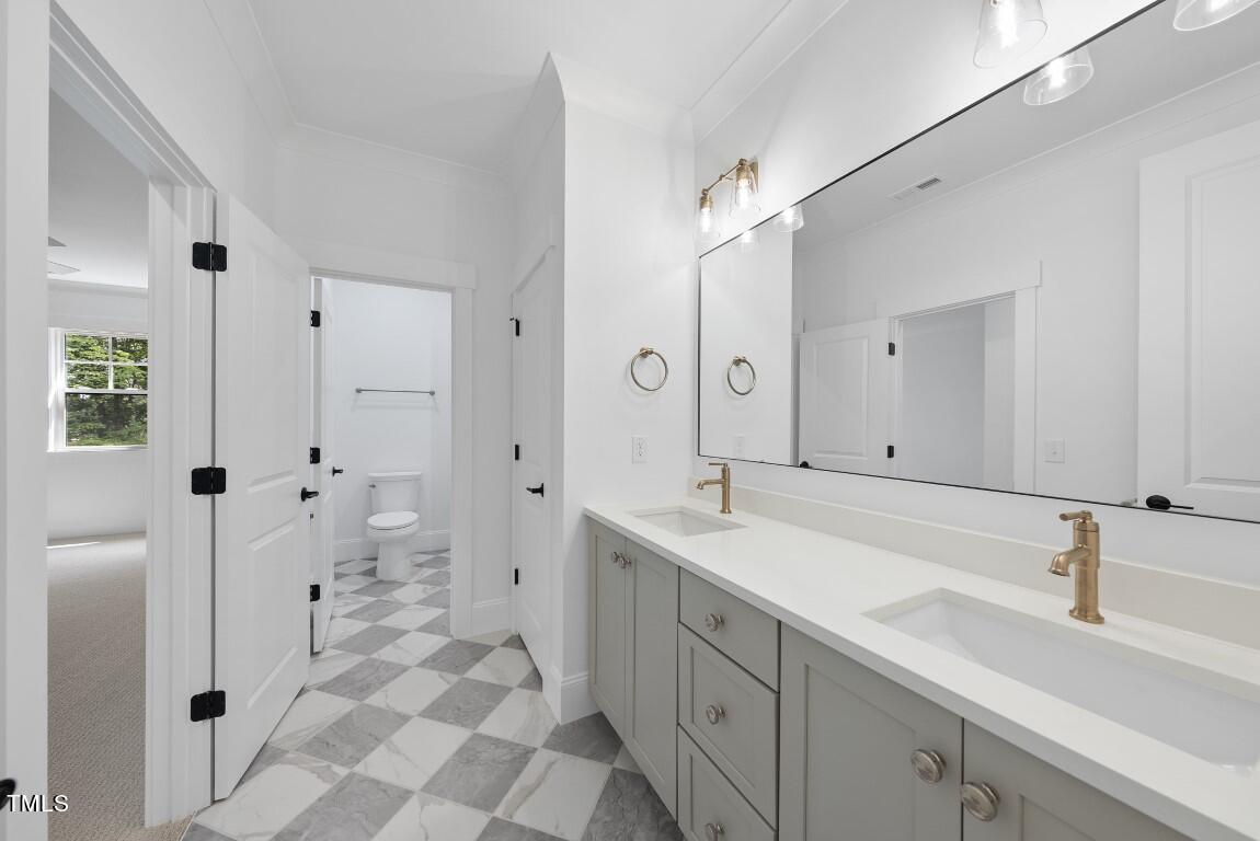 412 Vernon Terrace Raleigh, NC 27609 - Photo 38 of 67 a spacious bathroom with a shower sink and mirror