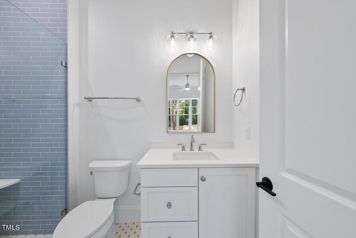 412 Vernon Terrace Raleigh, NC 27609 - Photo 46 of 67 a bathroom with a sink a toilet and a mirror