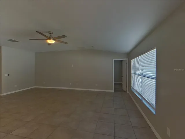 a kitchen with stainless steel appliances granite countertop a stove top oven a sink and a refrigerator