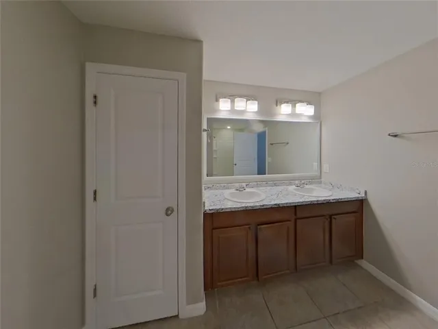 a bathroom with a granite countertop sink a toilet and shower
