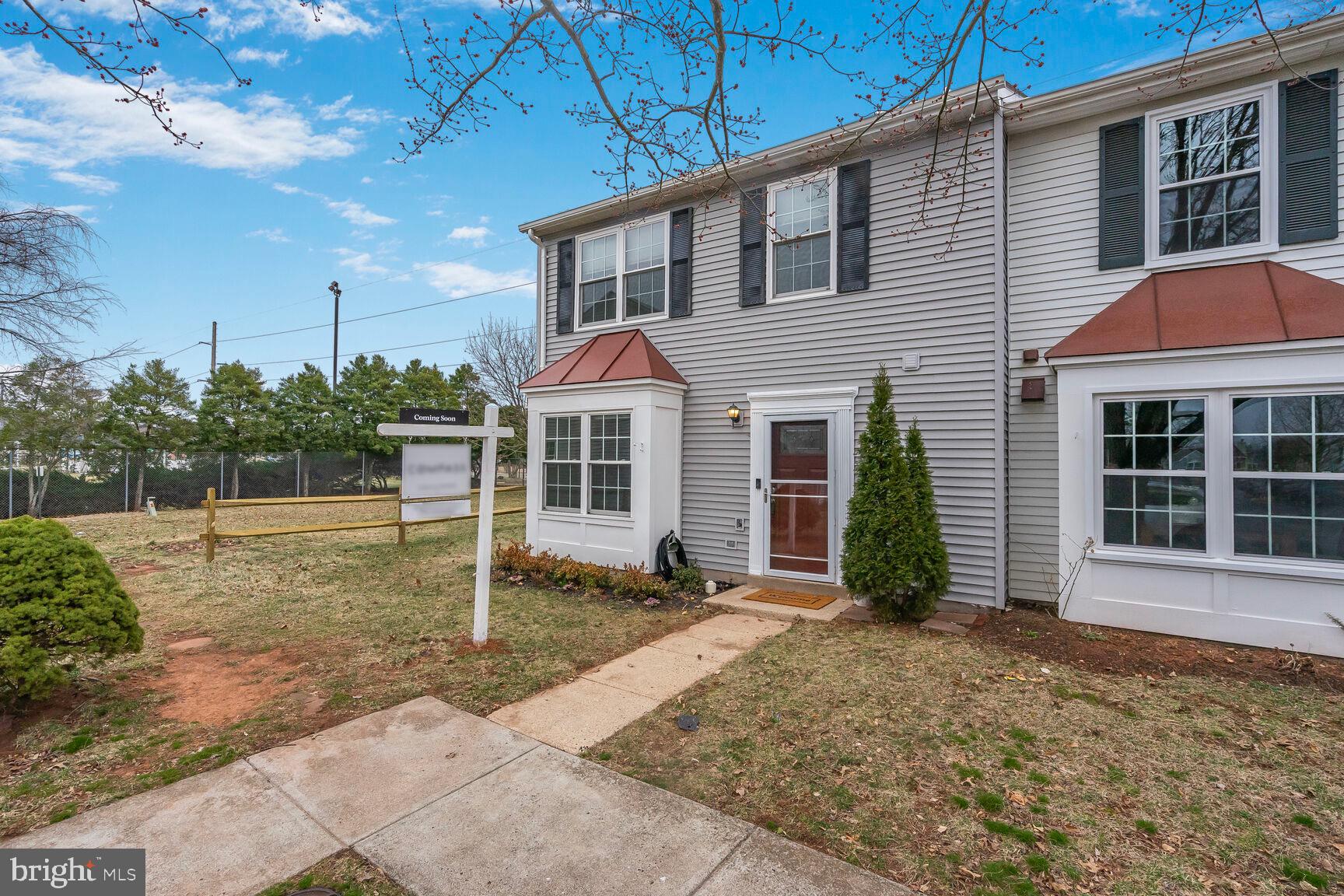 a view of a house with backyard and porch