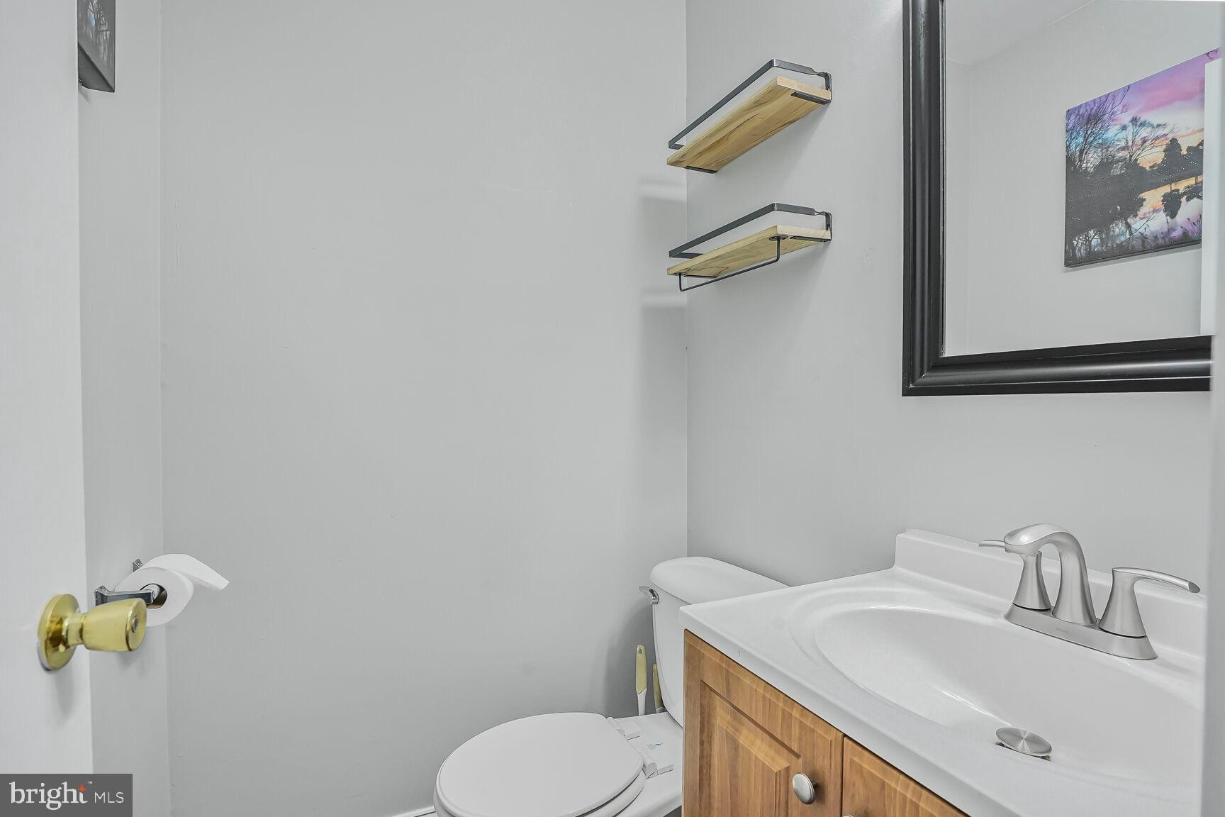 7810 Gateshead Lane Manassas, VA 20109 - Photo 11 of 20 a bathroom with a sink mirror vanity and toilet
