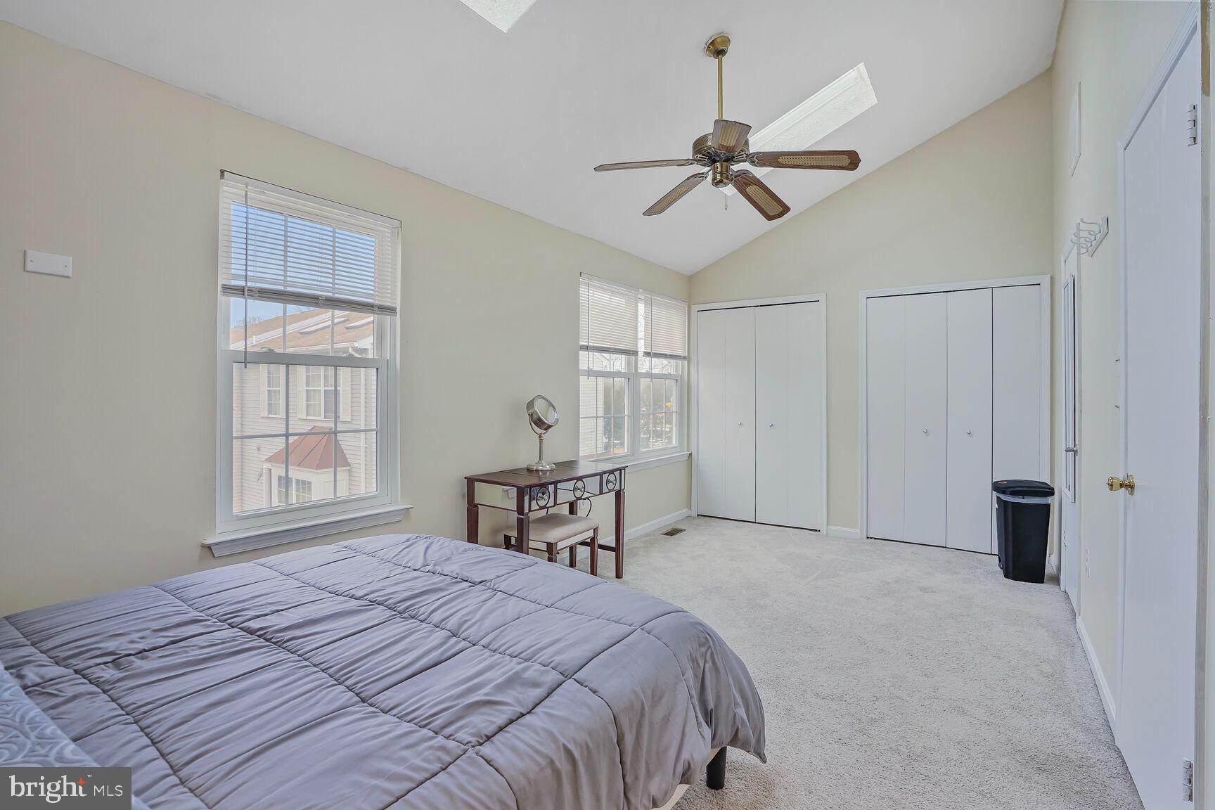 7810 Gateshead Lane Manassas, VA 20109 - Photo 13 of 20 a bedroom with a large bed and a chandelier