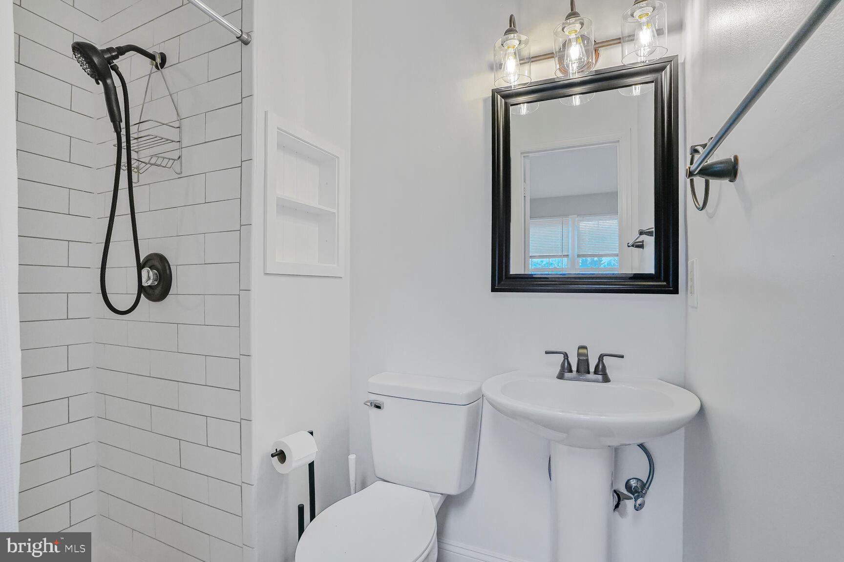 7810 Gateshead Lane Manassas, VA 20109 - Photo 14 of 20 a bathroom with a toilet sink and shower