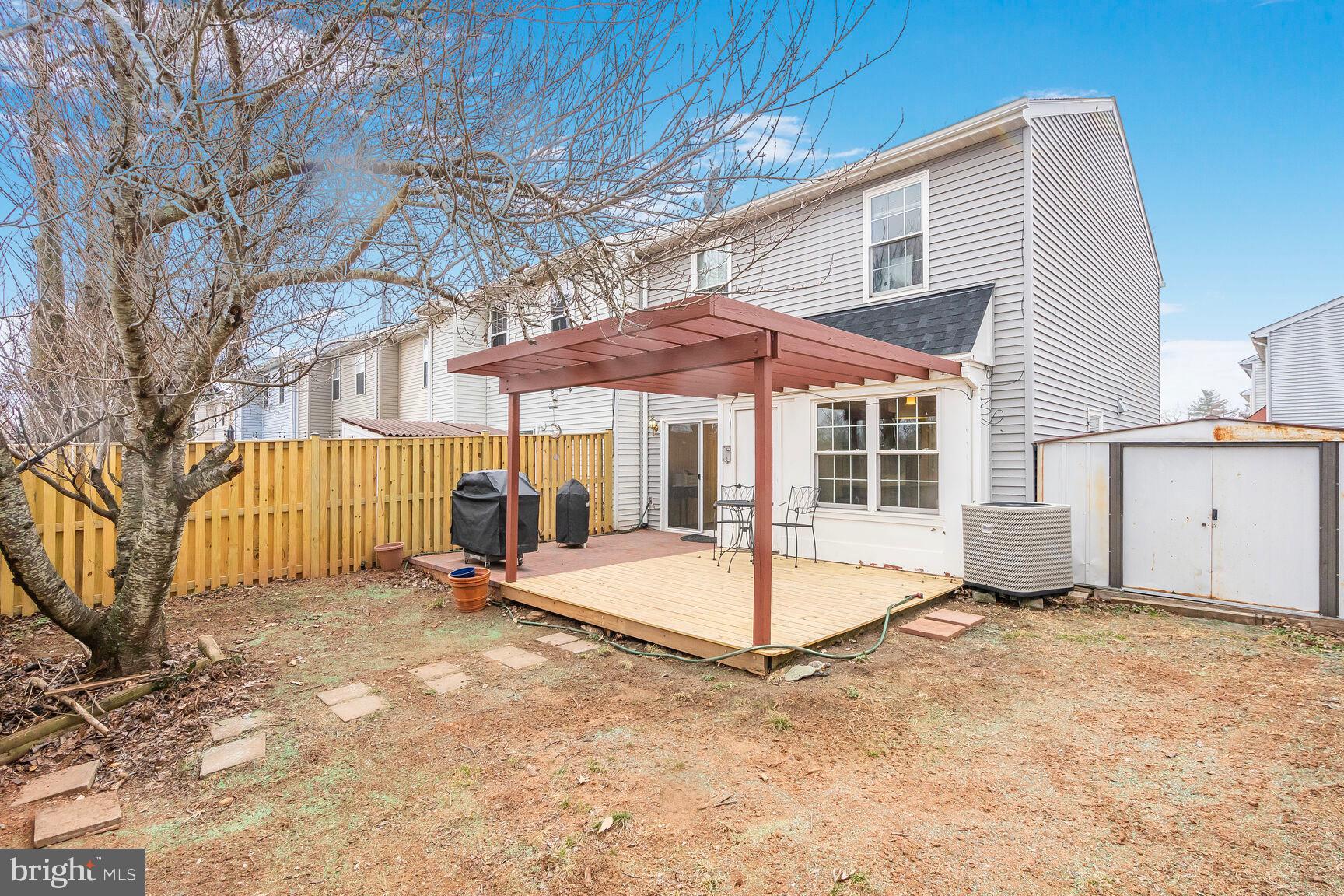 7810 Gateshead Lane Manassas, VA 20109 - Photo 20 of 20 a view of a house with a backyard and a table and chairs