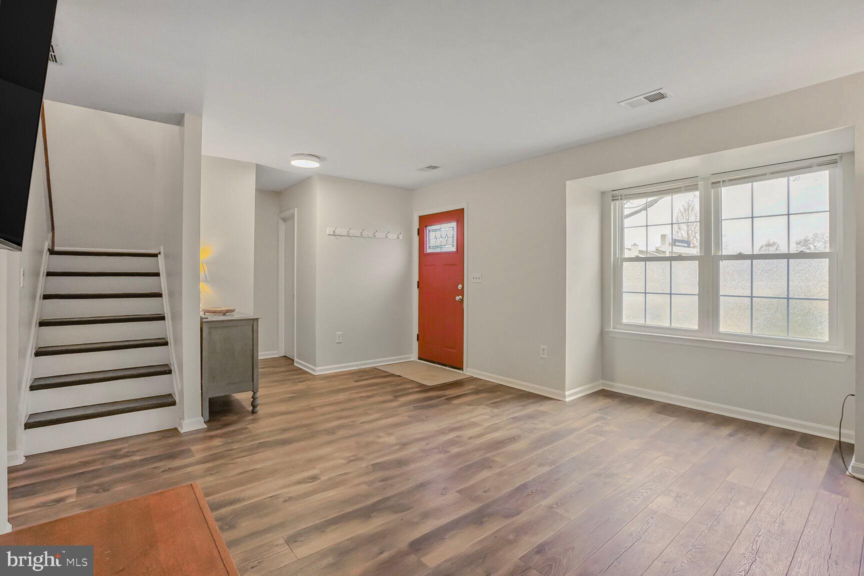 7810 Gateshead Lane Manassas, VA 20109 - Photo 3 of 20 an empty room with wooden floor and windows