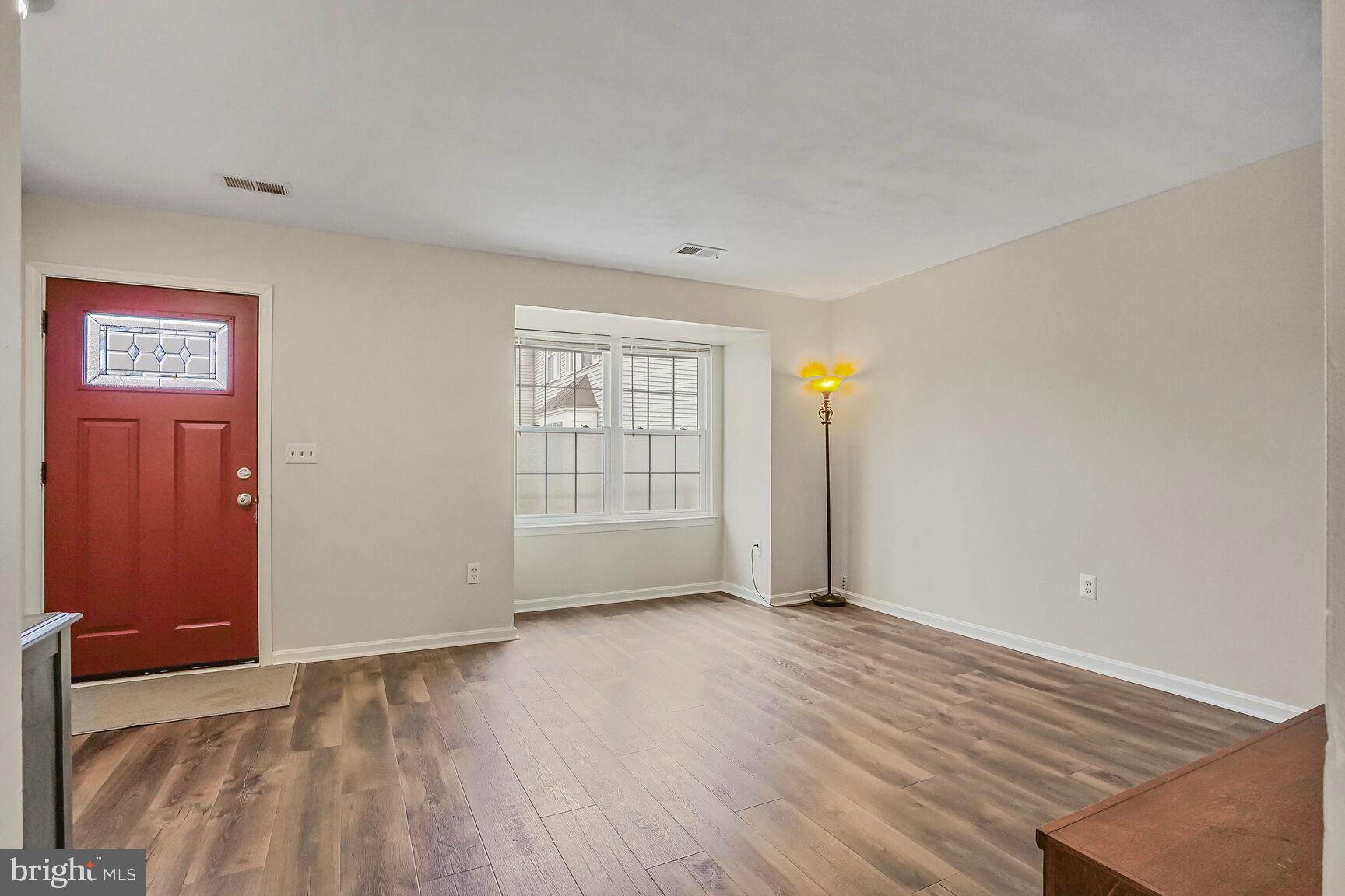 7810 Gateshead Lane Manassas, VA 20109 - Photo 7 of 20 an empty room with wooden floor and windows