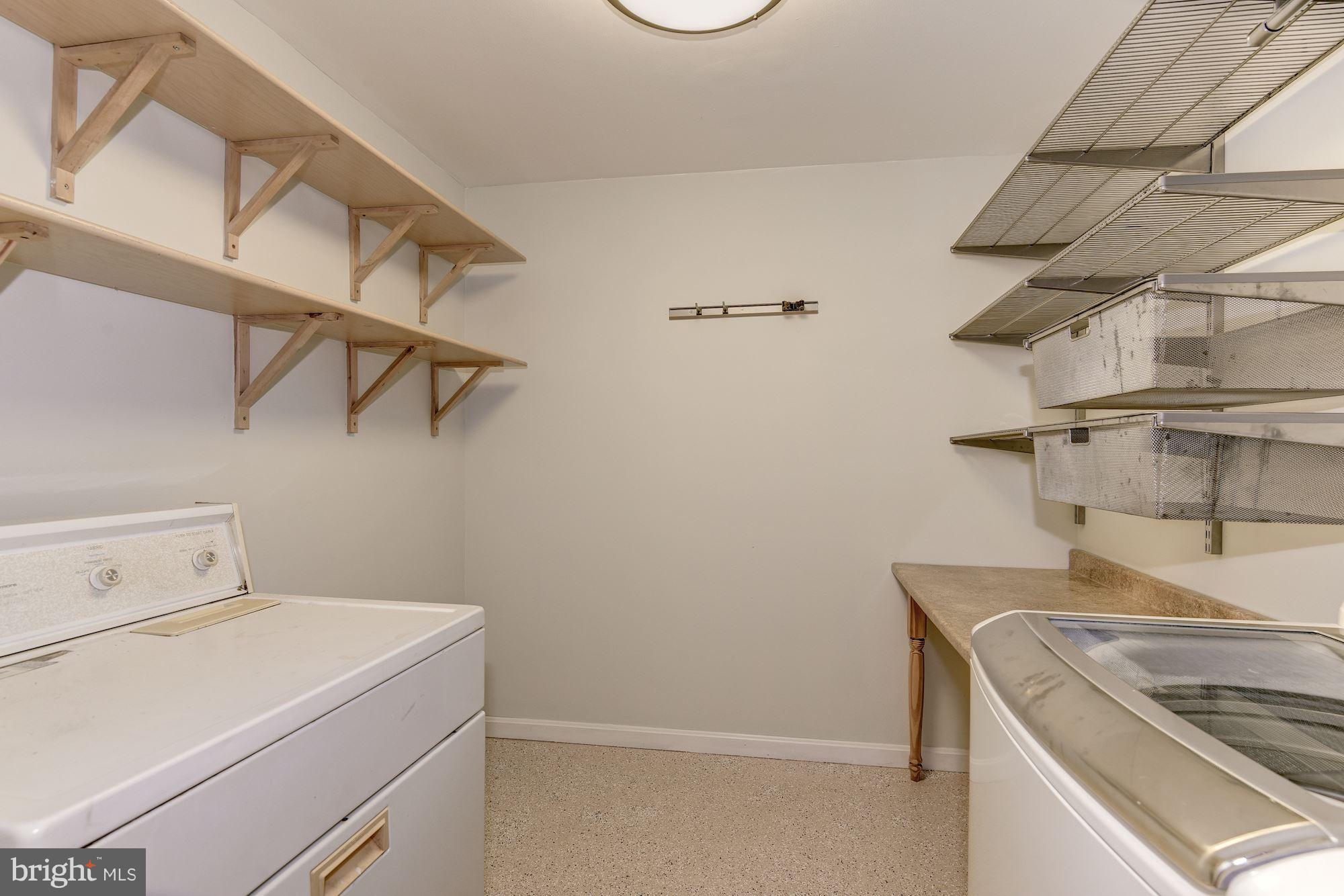 7729 Schelhorn Road Alexandria, VA 22306 - Photo 20 of 30 Laundry Room with folding table & Shelving!