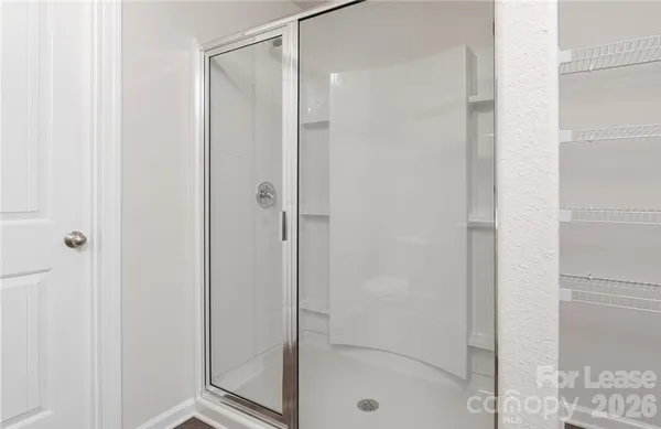 a bathroom with a glass shower door