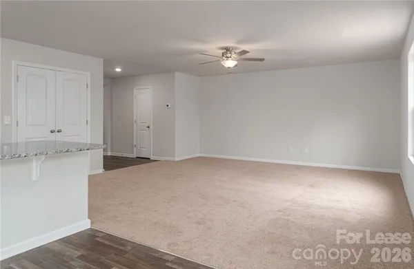 a view of a room with wooden floor and fan