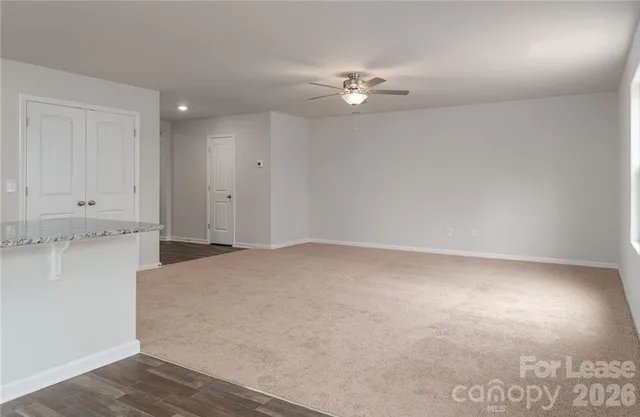 a view of a room with wooden floor and fan