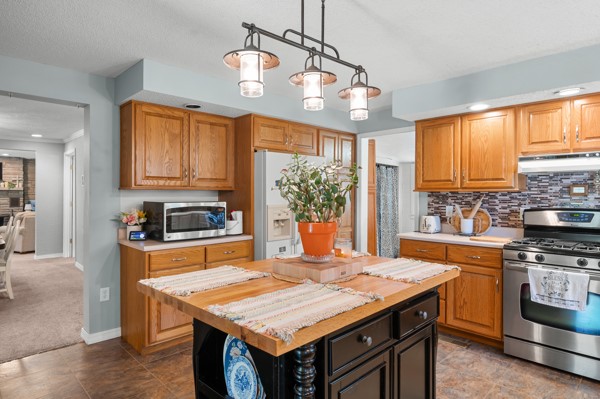 2476 East Washington Road Casey, IL 62420 - Photo 22 of 36 a kitchen with stainless steel appliances granite countertop a stove a sink dishwasher and a refrigerator with wooden floor