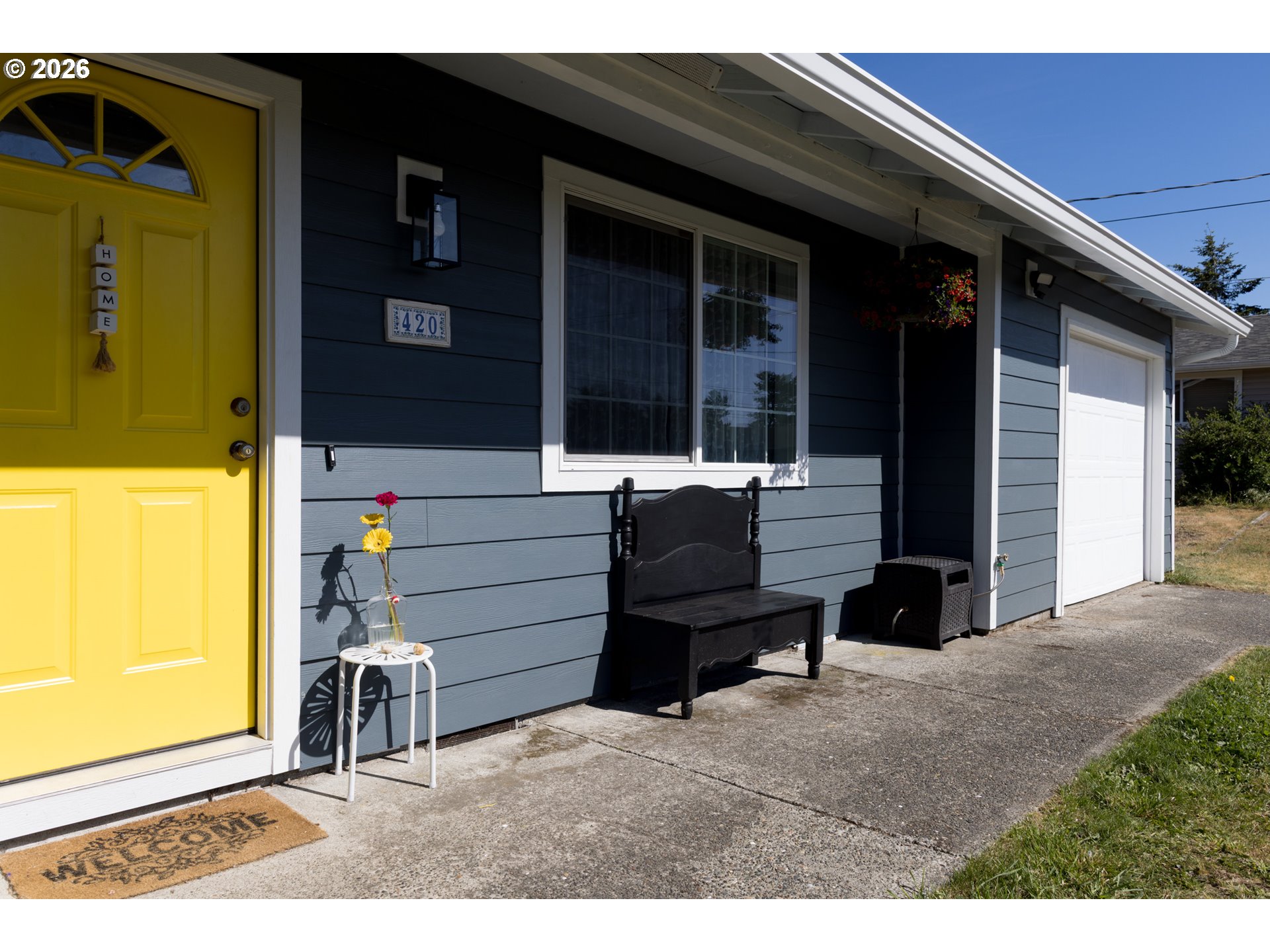 420 Juniper Street Florence, OR 97439 - Photo 2 of 34 a backyard of a house with barbeque oven table and chairs