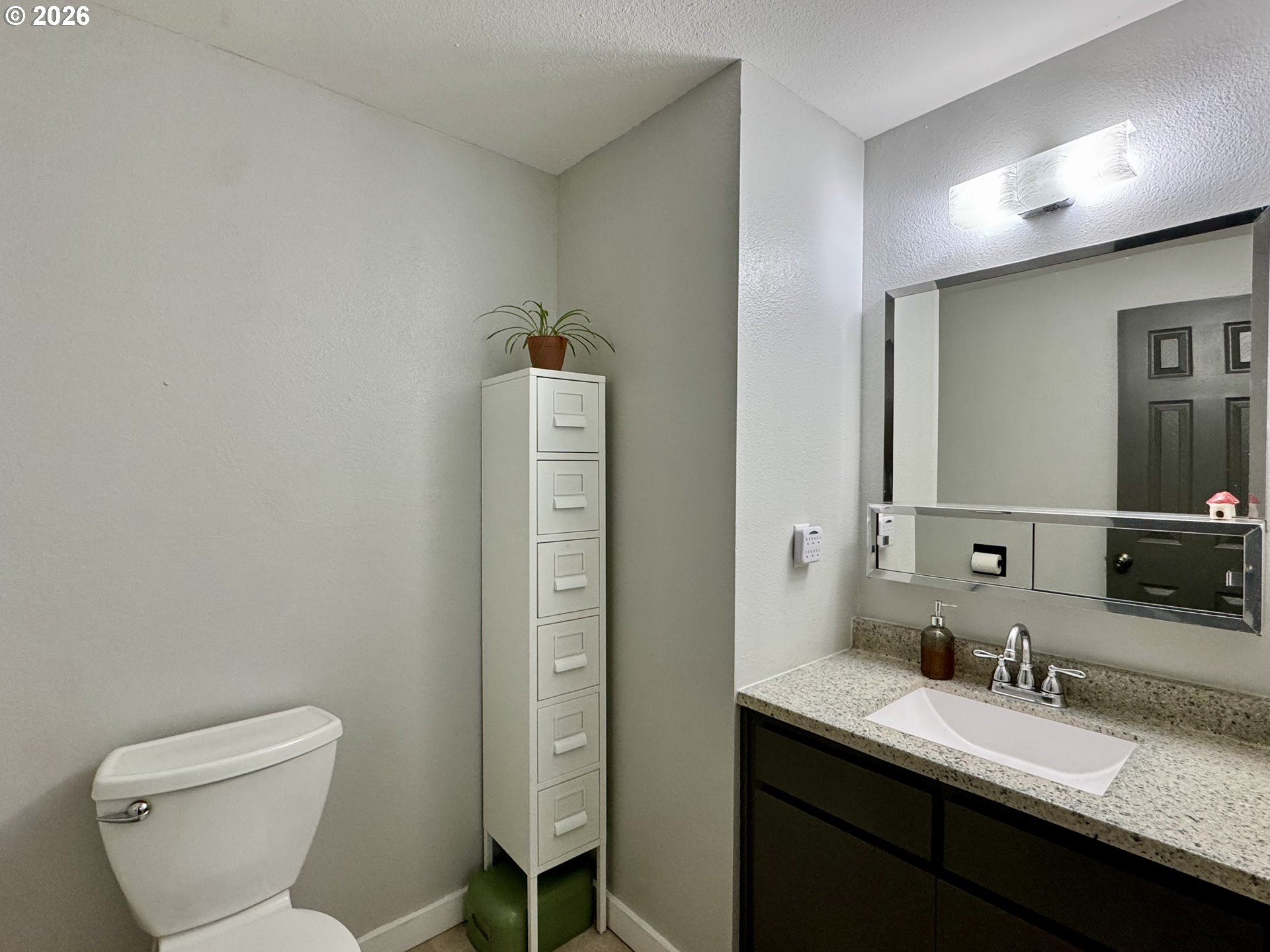 420 Juniper Street Florence, OR 97439 - Photo 26 of 34 a bathroom with a granite countertop toilet sink and mirror