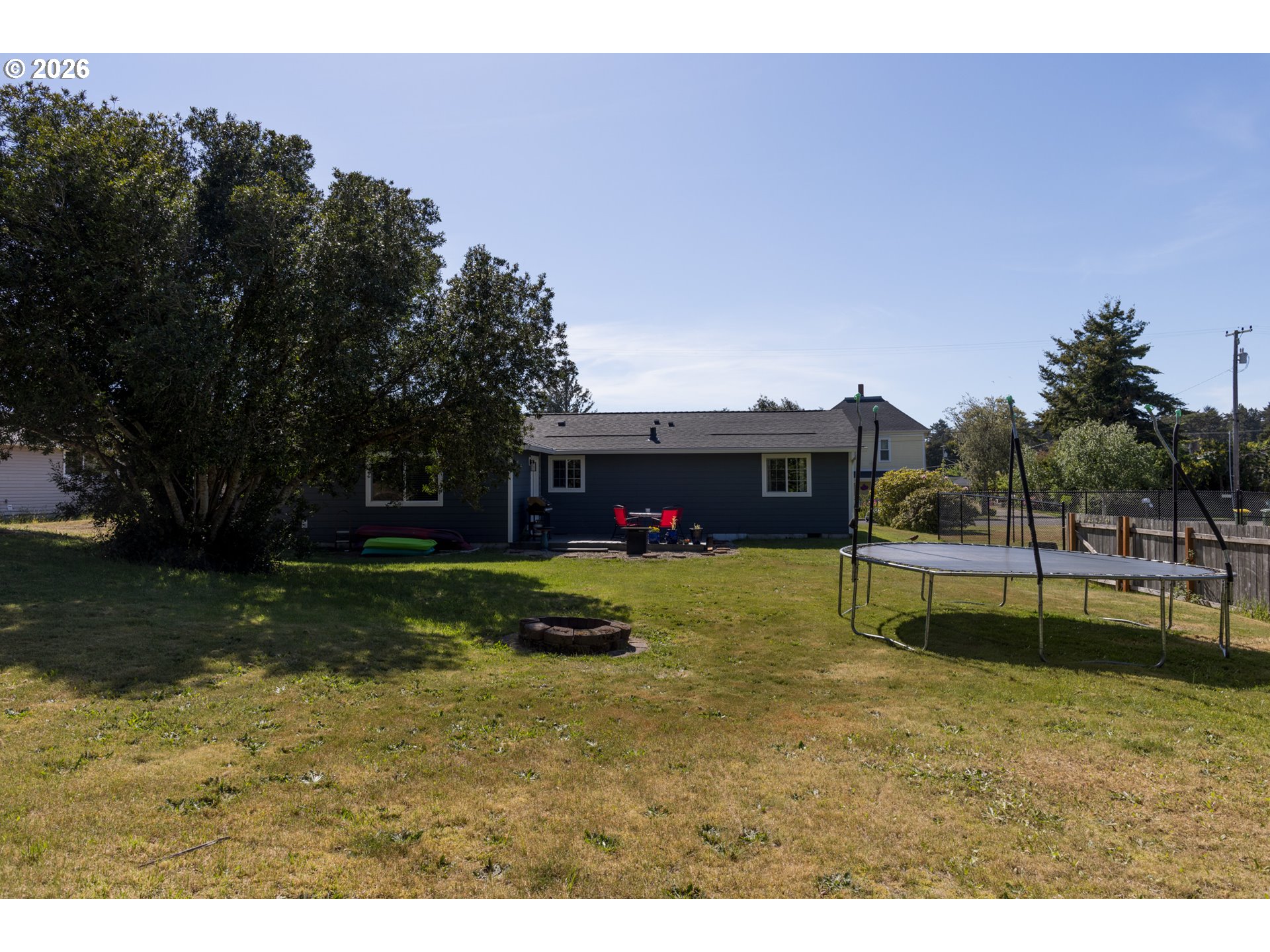 420 Juniper Street Florence, OR 97439 - Photo 30 of 34 a swimming pool with outdoor seating and yard